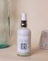 A pump bottle of facial cleanser with a label that reads &
