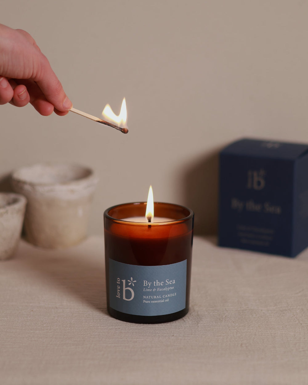 A natural soy wax candle by Love to b with a lime and eucalyptus scent named &