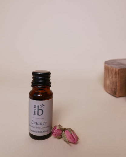 A small bottle of essential oil blend labeled &