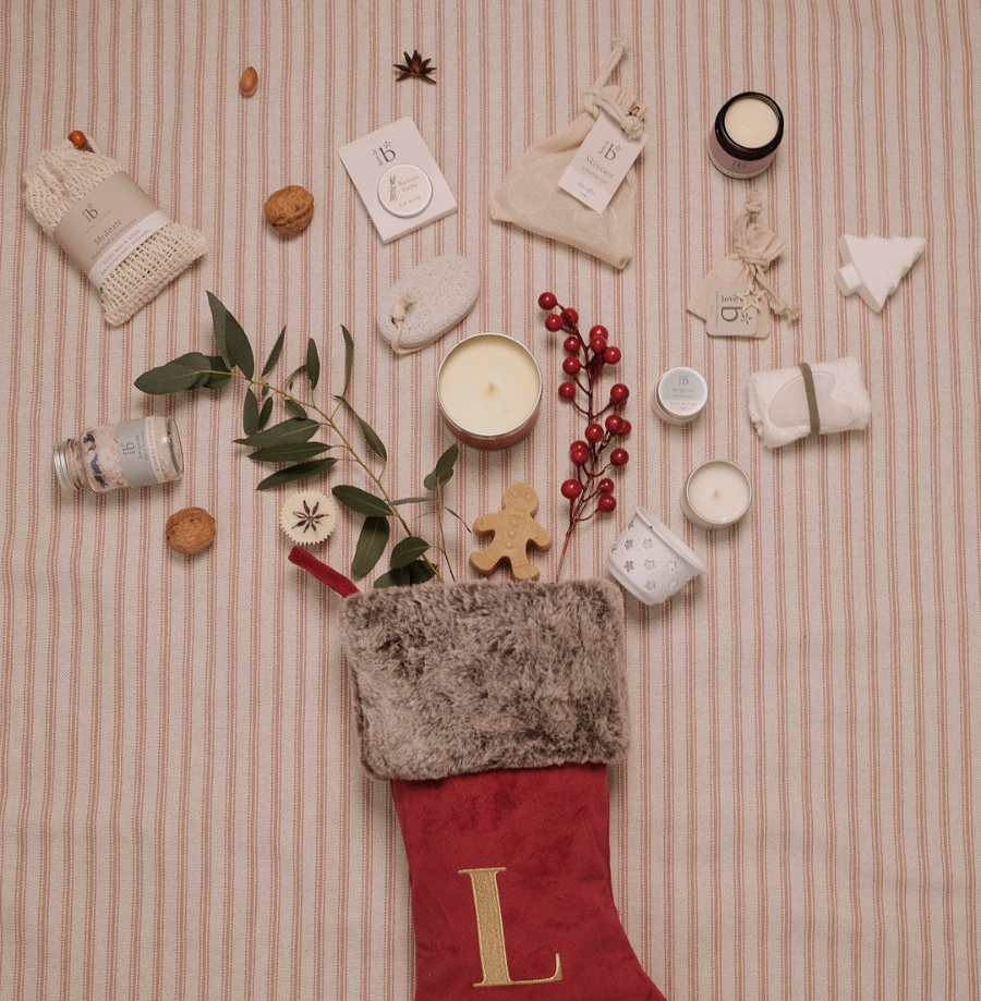 Love to b products placed on a striped background with a Christmas stocking below