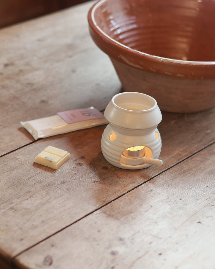 Love to b ‘Relax’ lavender &amp; rose geranium natural soy wax melt bar next to a ceramic wax burner