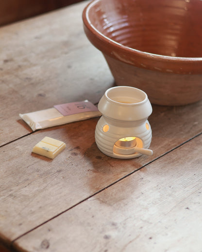 Love to b ‘Relax’ lavender &amp; rose geranium natural soy wax melt bar next to a ceramic wax burner